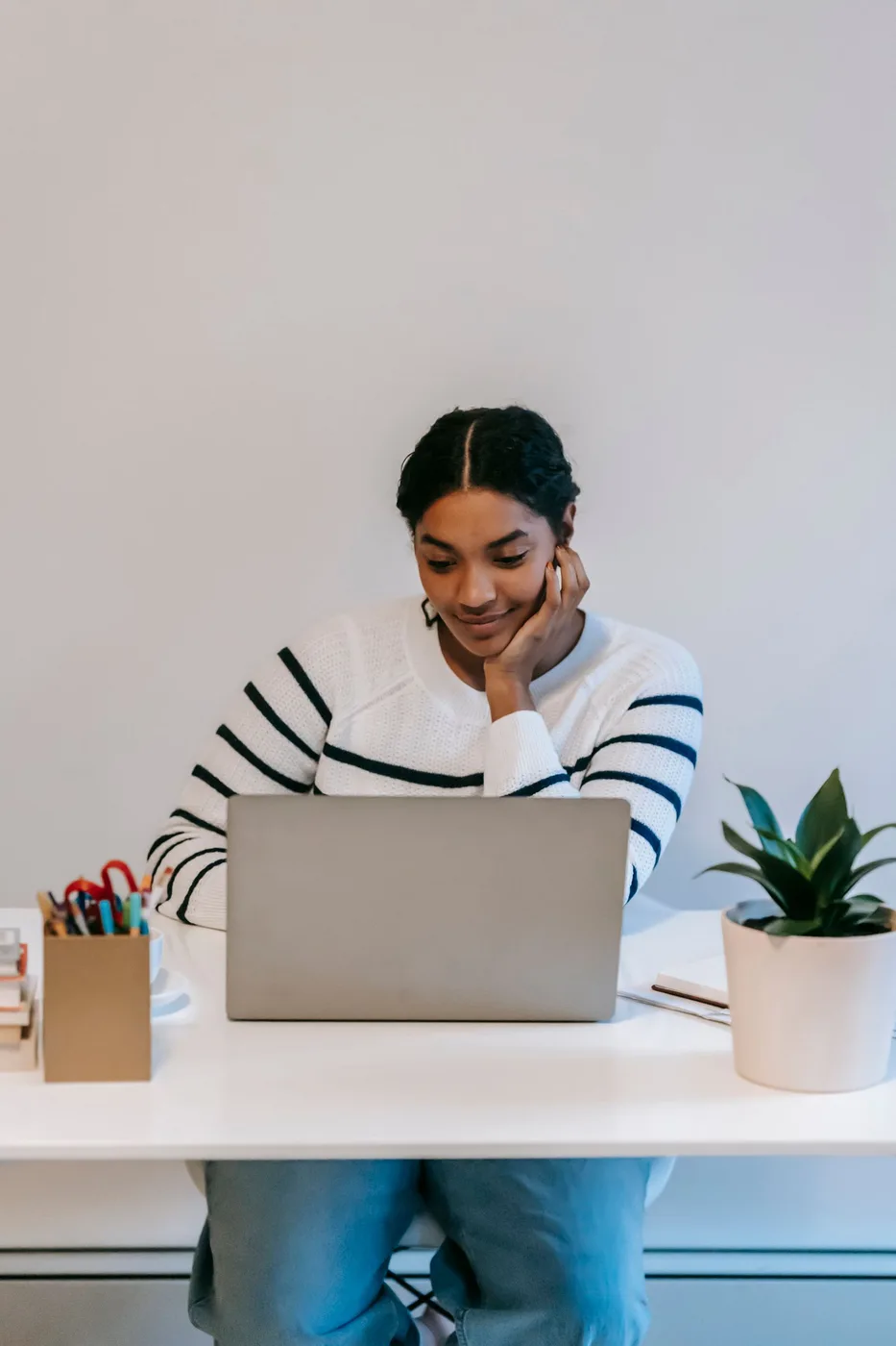Professional working on a laptop in a bright home workspace